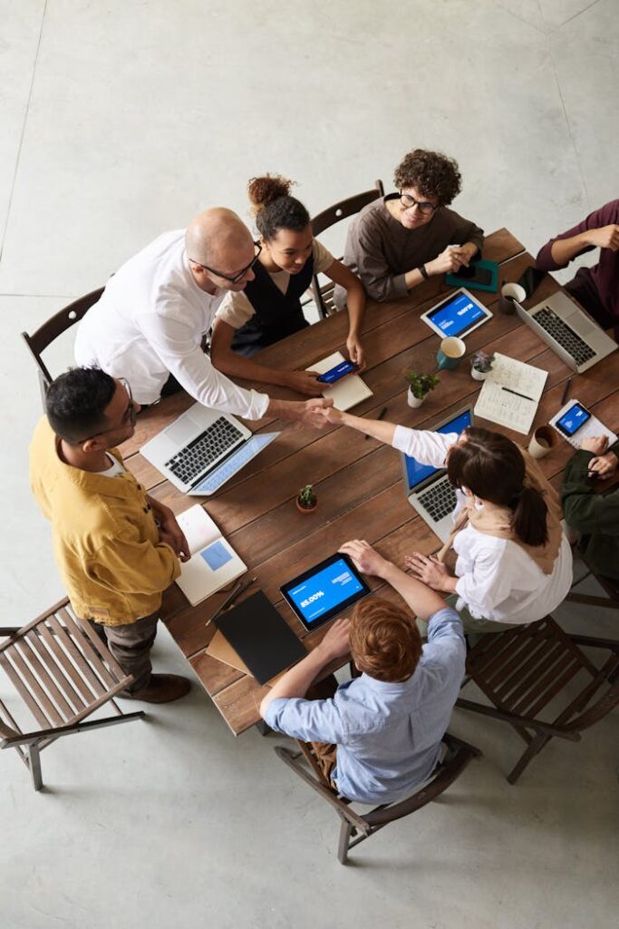 pexels photo 3183172 Overhead shot of a diverse team collaborating in a modern office meeting.